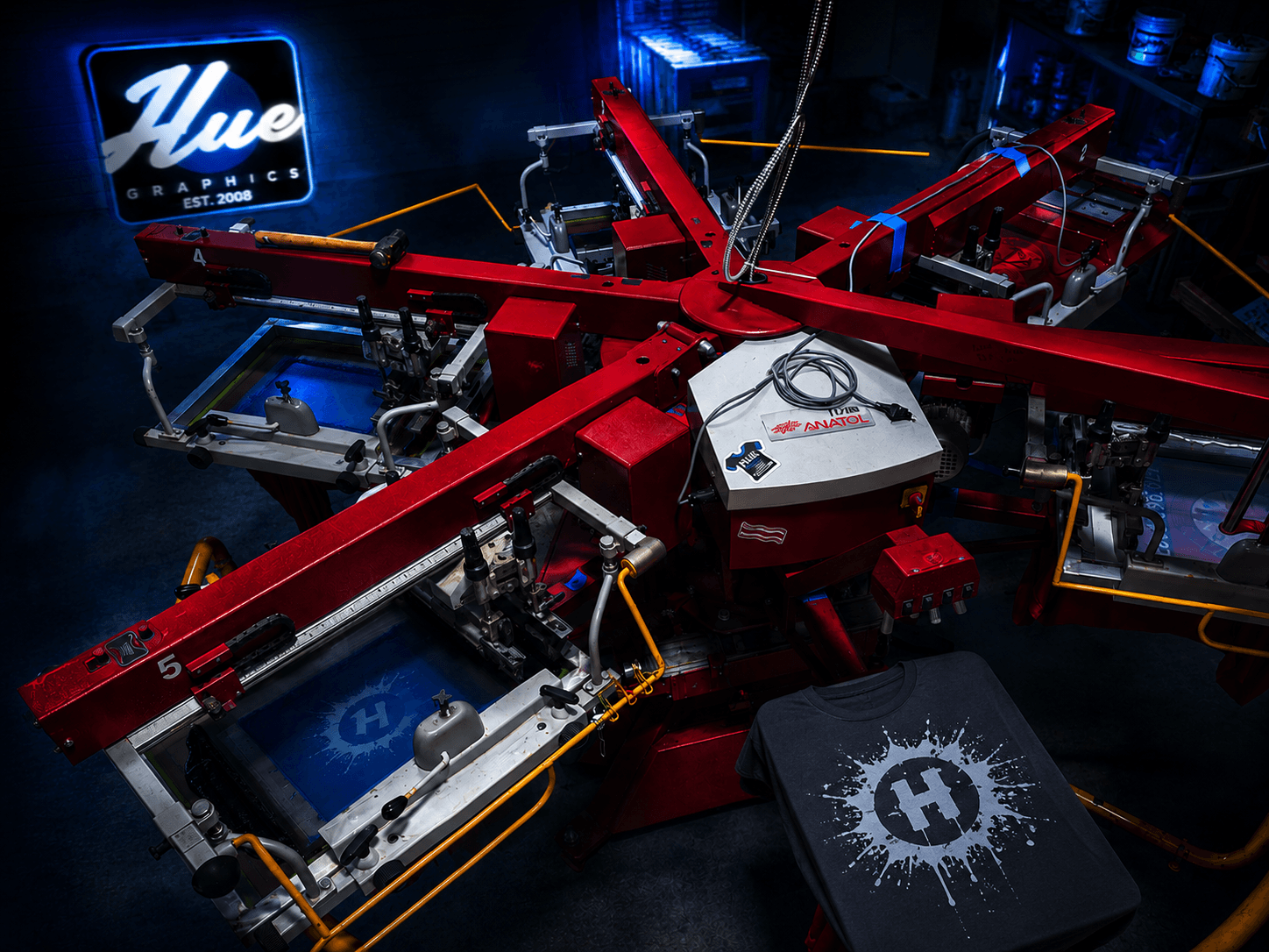 Screen printing press on the Hue Graphics production floor